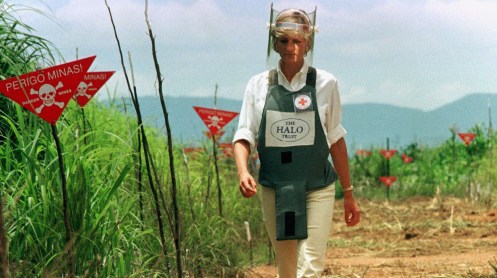 Diana, Princess of Wales, walks in one of the safety corridors of the land mine field of Huambo, Jan..